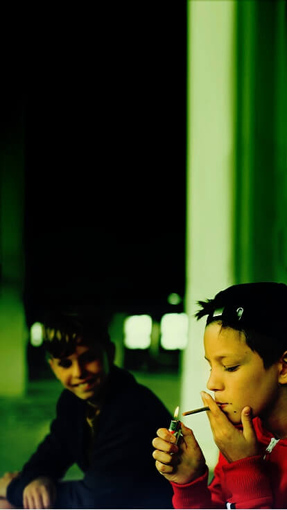 Young boy lighting a joint.